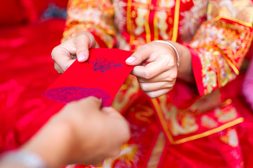 Chinese bride giving red pocket lucky money in the wedding