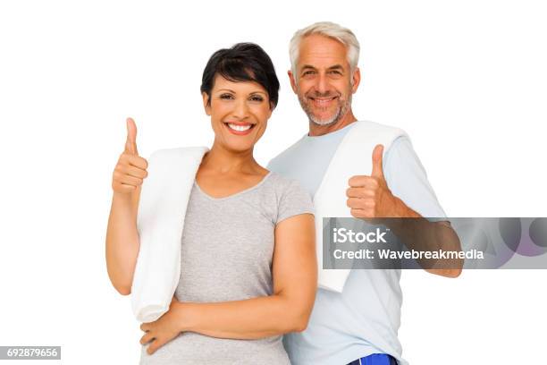 Portrait Of A Happy Fit Couple Gesturing Thumbs Up Stock Photo - Download Image Now - Couple - Relationship, Exercising, Thumbs Up