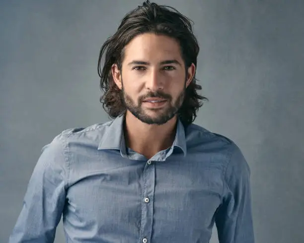 Cropped shot of a handsome young man posing against a grey background