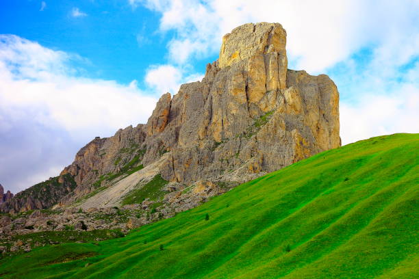 Passo Giau dramatic landscape, bright pinnacle and green meadows – Idyllic Mountain pass in Northern Italy Dolomites alps at sunset, near Cortina d'Ampezzo