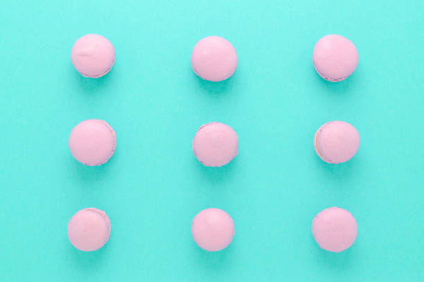 pink macaroons homemade on turquoise background top view
