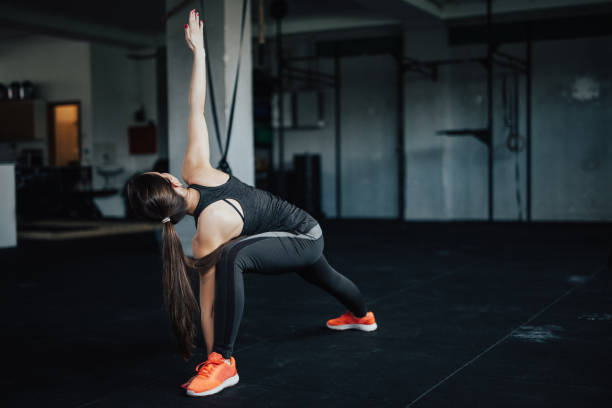 istock Beautiful yoga woman doing extended triangle pose 692883524