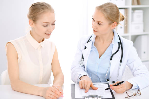 istock Doctor and  patient  sitting at the desk 692886770