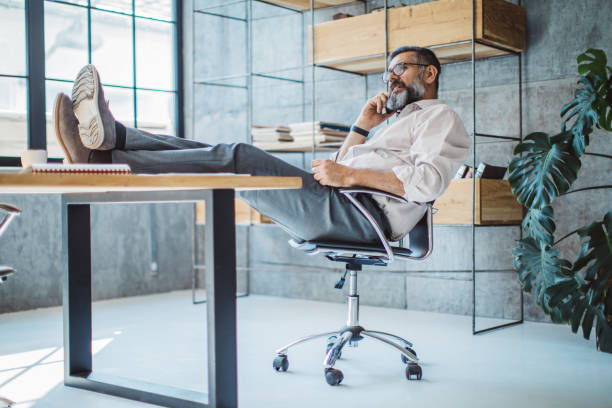 istock Talking a phone call from his coworker 692887316