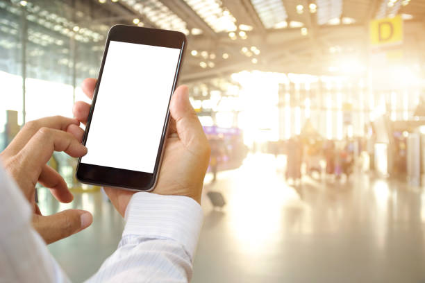 istock Man hands holding blank screen smartphone in terminal airport. 692887894