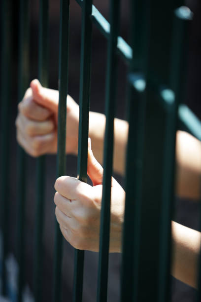 istock hand of prisoner in jail 692891470