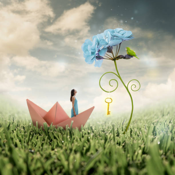 Photo manipulation: unlocking the power of individual potential Black haired young woman looks up at a blown up flower with a parrot and a golden key hanging from its spiralling leaf on a shining field of grass illusion photos stock pictures, royalty-free photos & images