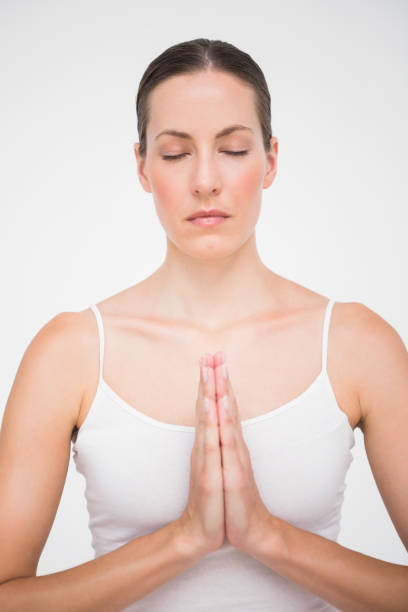 istock Fit woman meditating with hands crossed 692904550