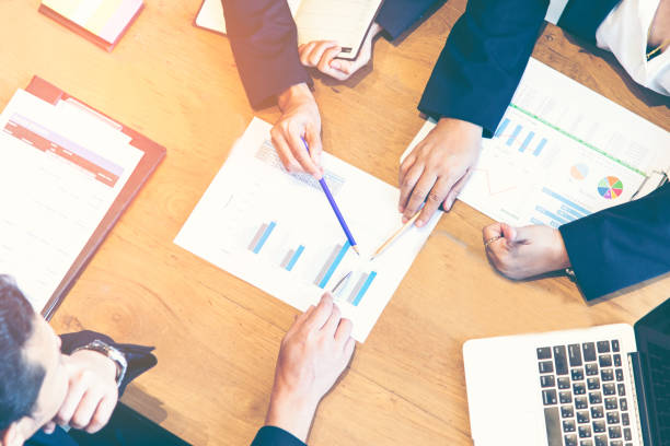 istock Close-up of business partners hands over papers discussing them 692905464