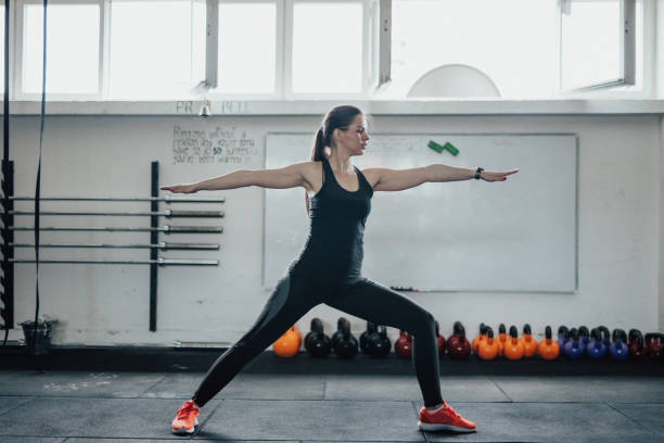 istock Yoga woman doing warrior pose II 692905622
