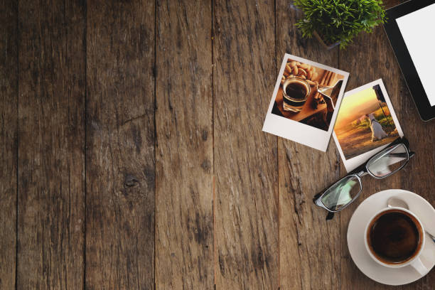 istock Coffee cup, Vintage instant photo frame and tablet pc on rustic wooden background. 692908632
