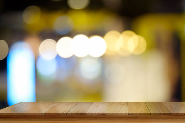 istock Empty top wood table and blur city night background. 692909022
