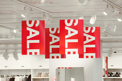 Sale signs hanging from the ceiling.
