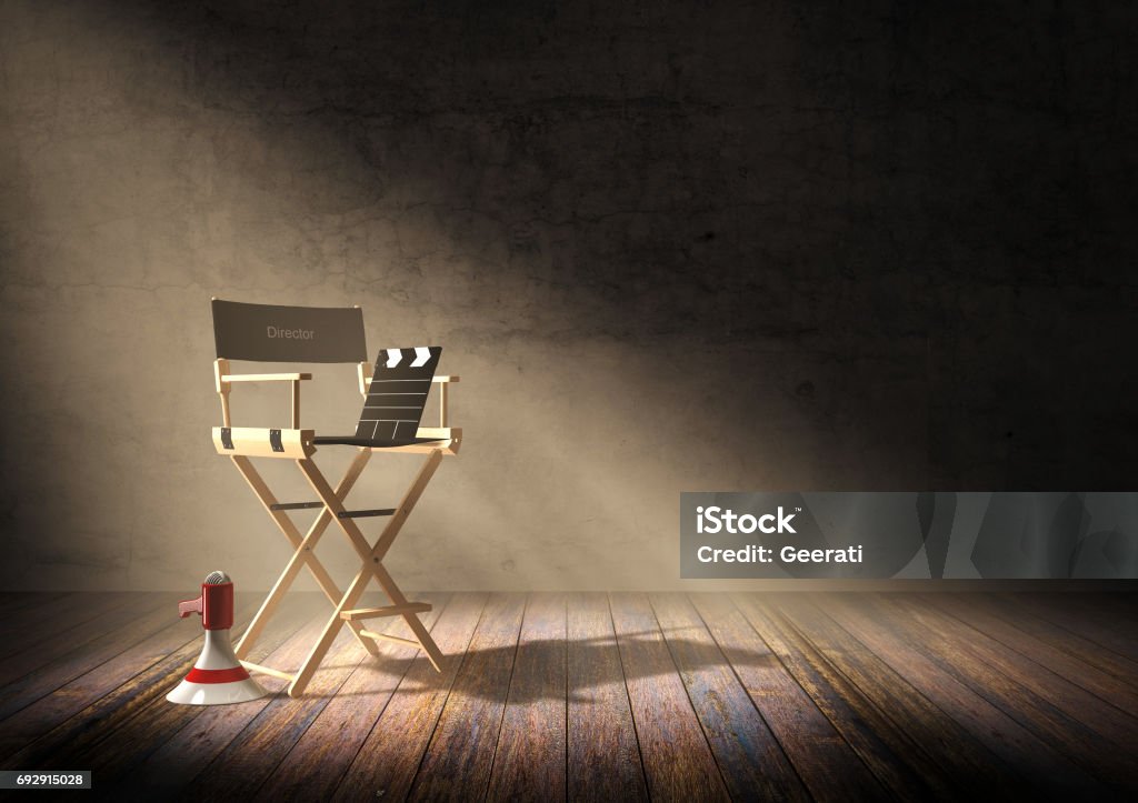 Director's chair with clapper board and megaphone in dark room Director's chair with clapper board and megaphone in dark room scene with spotlight light, 3D rendering Director's Chair Stock Photo