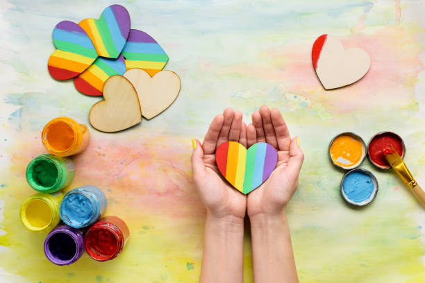 istock Lbgt rainbow hearts in hands top view 692919648