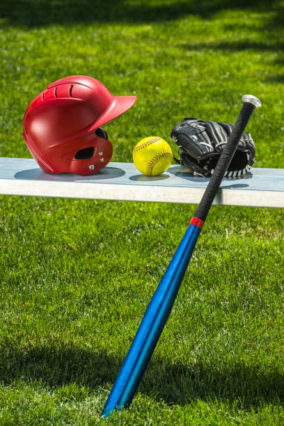 yellow softball, glove, bat and helmet on bench - softball playing field fluorescent team sport imagens e fotografias de stock