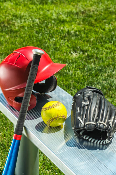 yellow softball, glove, bat and helmet on bench - softball playing field fluorescent team sport imagens e fotografias de stock