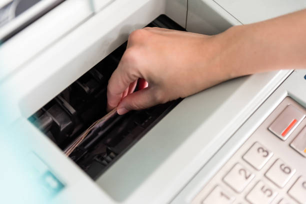 lady's hand pressing ATM pin for cash withdrawal