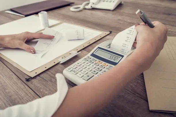 Photo of Accountant or businesswoman balancing the books