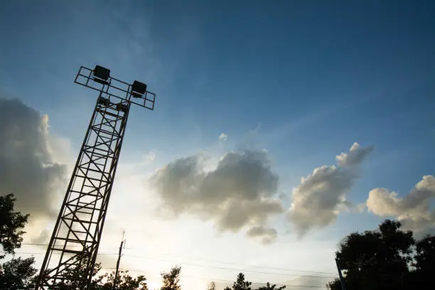 Photo of Silhouette of outdoor stadium halogen spotlight pole.