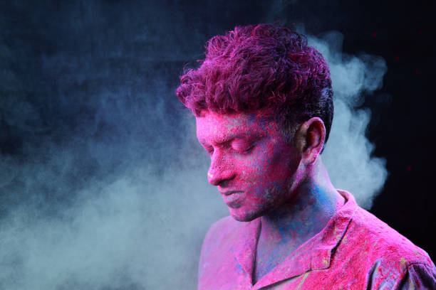istock Young man plays Indian festival Holi 692928018
