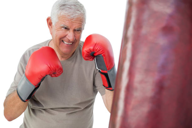 Portrait of a determined senior boxer over white background
