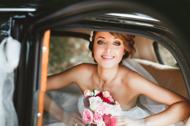 istock Beautiful bride sitting in wedding car 692930432