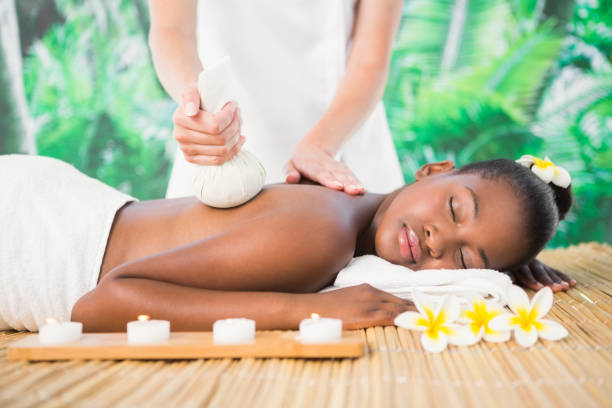 istock Pretty woman enjoying a herbal compress massage 692931132