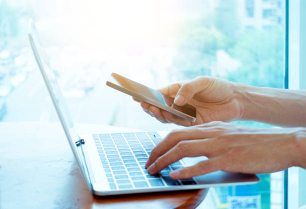 istock Businessman using laptop and smart phone 692938520