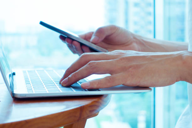 istock Businessman using laptop and smart phone 692938584