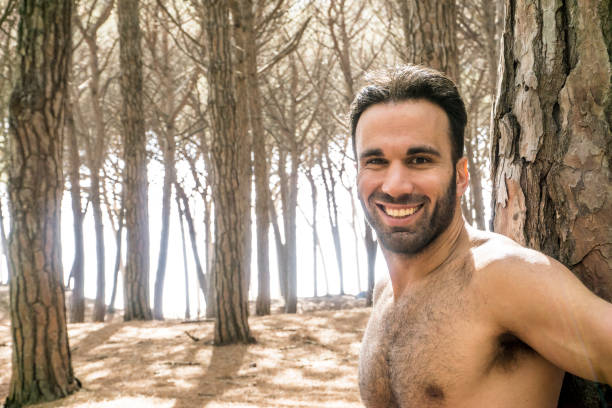 istock Handsome shirtless man in pine forest 692947964