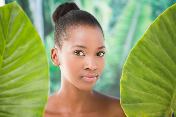 istock Pretty woman looking through leaves 692948012