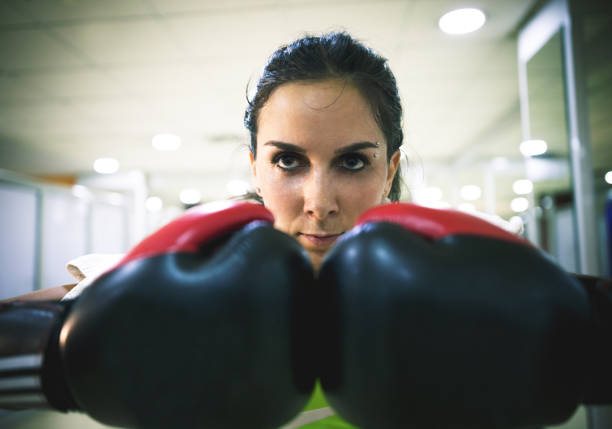 istock Female kickboxer training with a punching bag 692948220