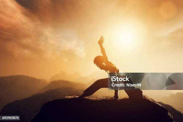 Asian Man Fighter Practices Martial Arts In High Mountains At Sunset Stock Photo - Download Image Now