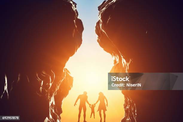 Happy Family In Between Two Mountains At The Entrance Of New Better World Stock Photo - Download Image Now