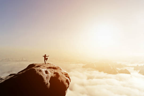 istock Asian man, fighter practices martial arts in high mountains above clouds. 692951882