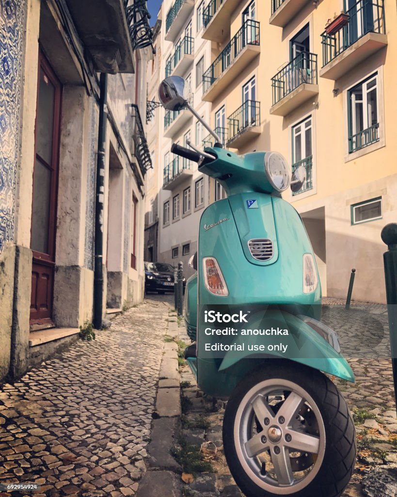 Vespa parked on old Lisbon street, Portugal Lisbon, Portugal - May 03, 2017: Vespa parked on old Lisbon street, Portugal Vespa - Brand Name Stock Photo