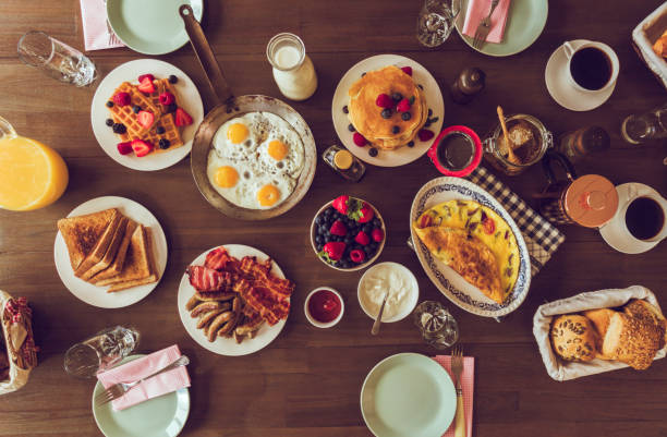 istock Having Breakfast with Eggs, Bacon, Yogurt with Fresh Fruits 692955148