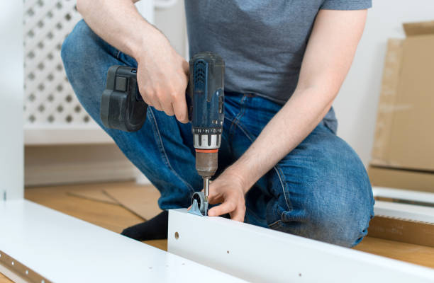 istock Repairman using screw gun. Close-up view. 692959270
