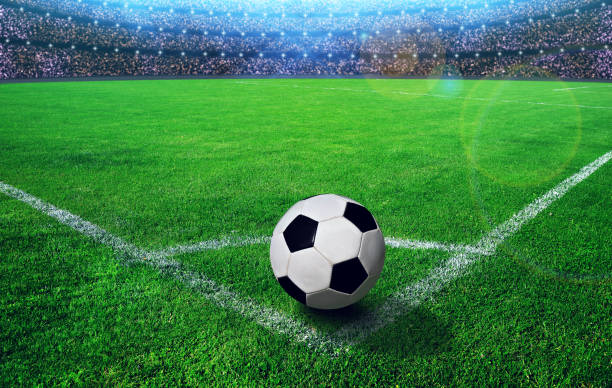 istock Soccer ball on grass in stadium. 692962316