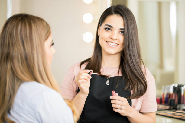 istock Cute Latin makeup artist at work 692972820