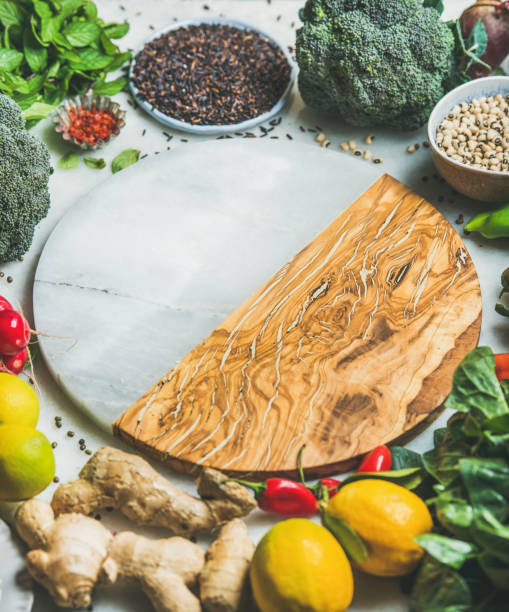 istock Vegetables, beans, grains, greens, fruit, spices, round board in center 692986502