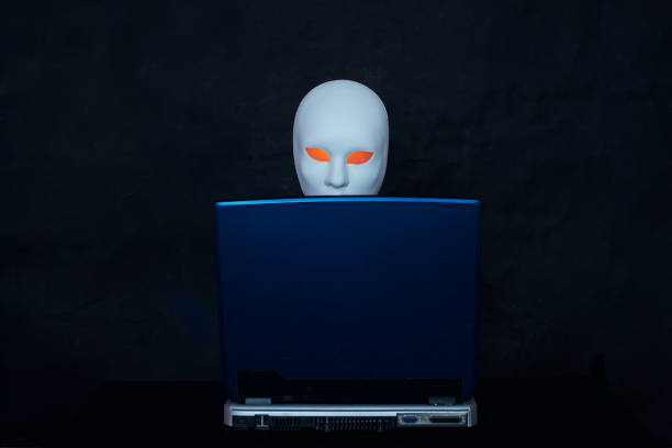 istock Concept of terrorism.Mask and laptop on dark 692990238