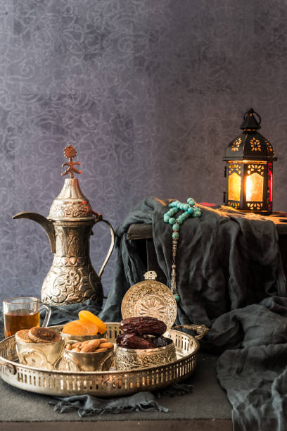 Ramadan kareem with premium dates,nuts and arabic tea. Festive still life with oriental ramadan lantern and iftar food concept.