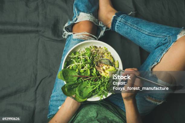 Vegetarian Breakfast Bowl With Spinach Arugula Avocado Seeds And Sprouts Stock Photo - Download Image Now