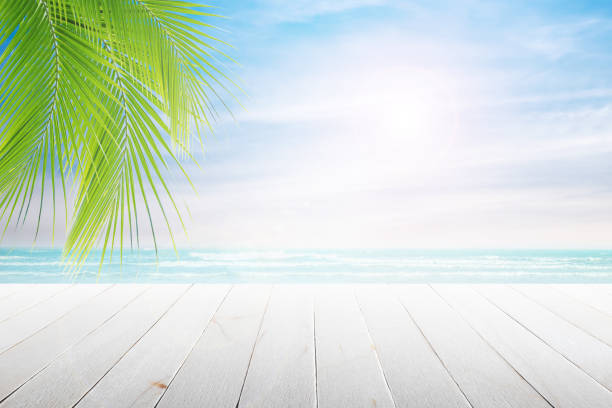 istock old wood table top on blurred beach background. 692993328