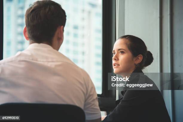 Young Businesswoman Discussing With Businessman At Office Stock Photo - Download Image Now