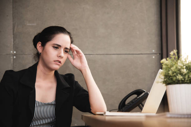 istock Businesswoman having headache from overwork at the office. 692993560