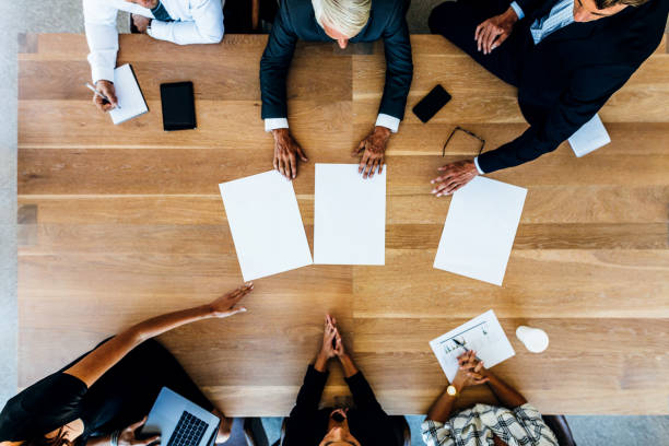 istock Group of businesspeople placing blank placards on table 692999016