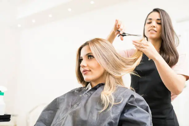 Photo of Hairdresser cutting some hair tips